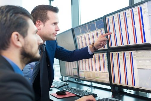 10 Mysteries About the 9/11 Terror Attack 7 two men looking at bank of computer screens. day traders